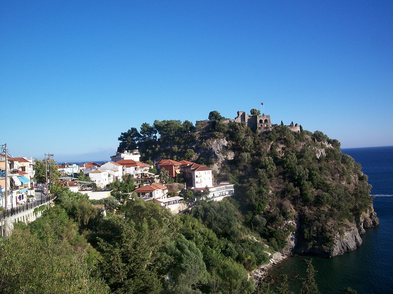 The castle of Parga on a rocky headland above the sea, with houses below it.